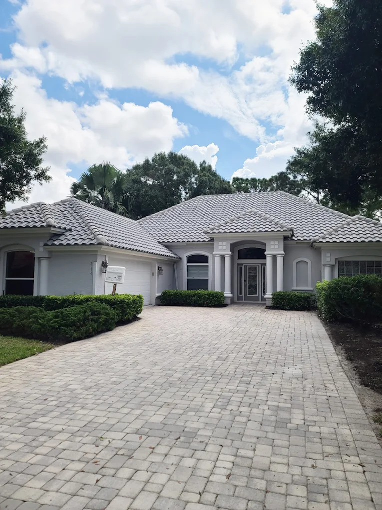 Completed gray tile roof replacement on a Port St. Lucie luxury home