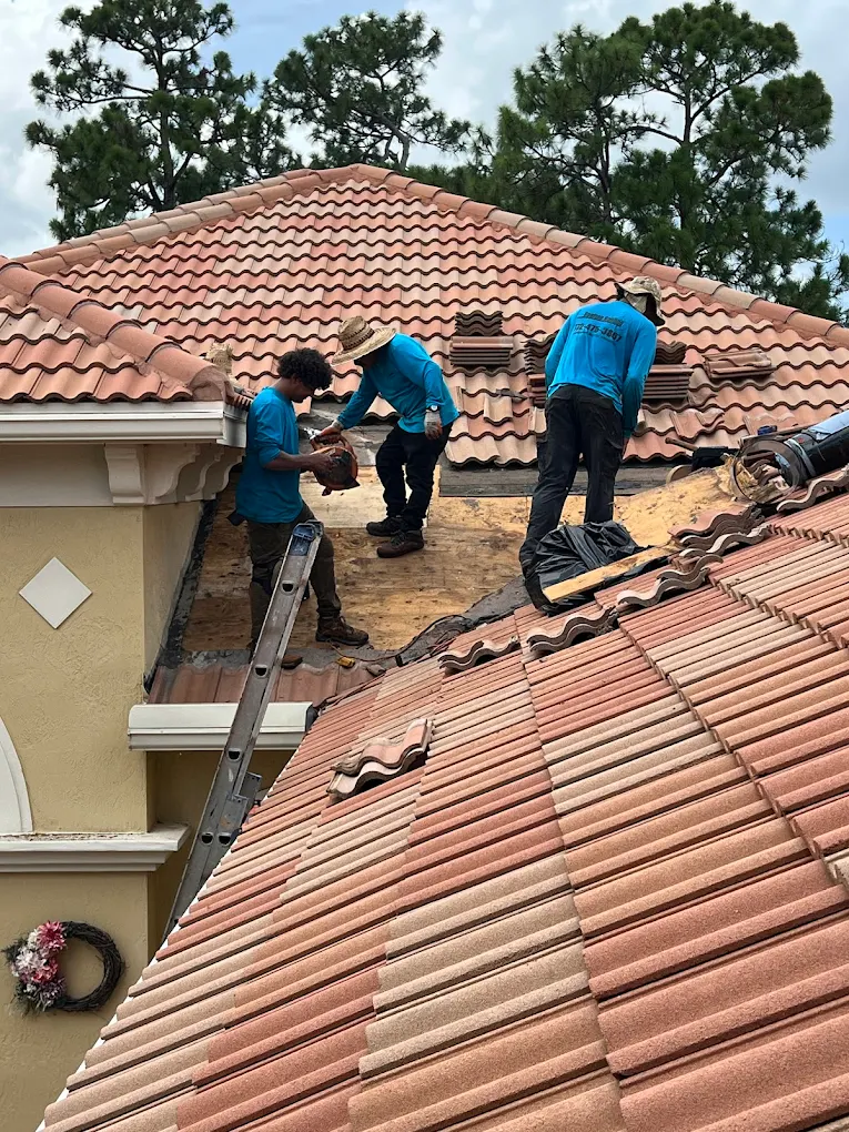 Rooftop Roofing crew performing emergency tile roof repair